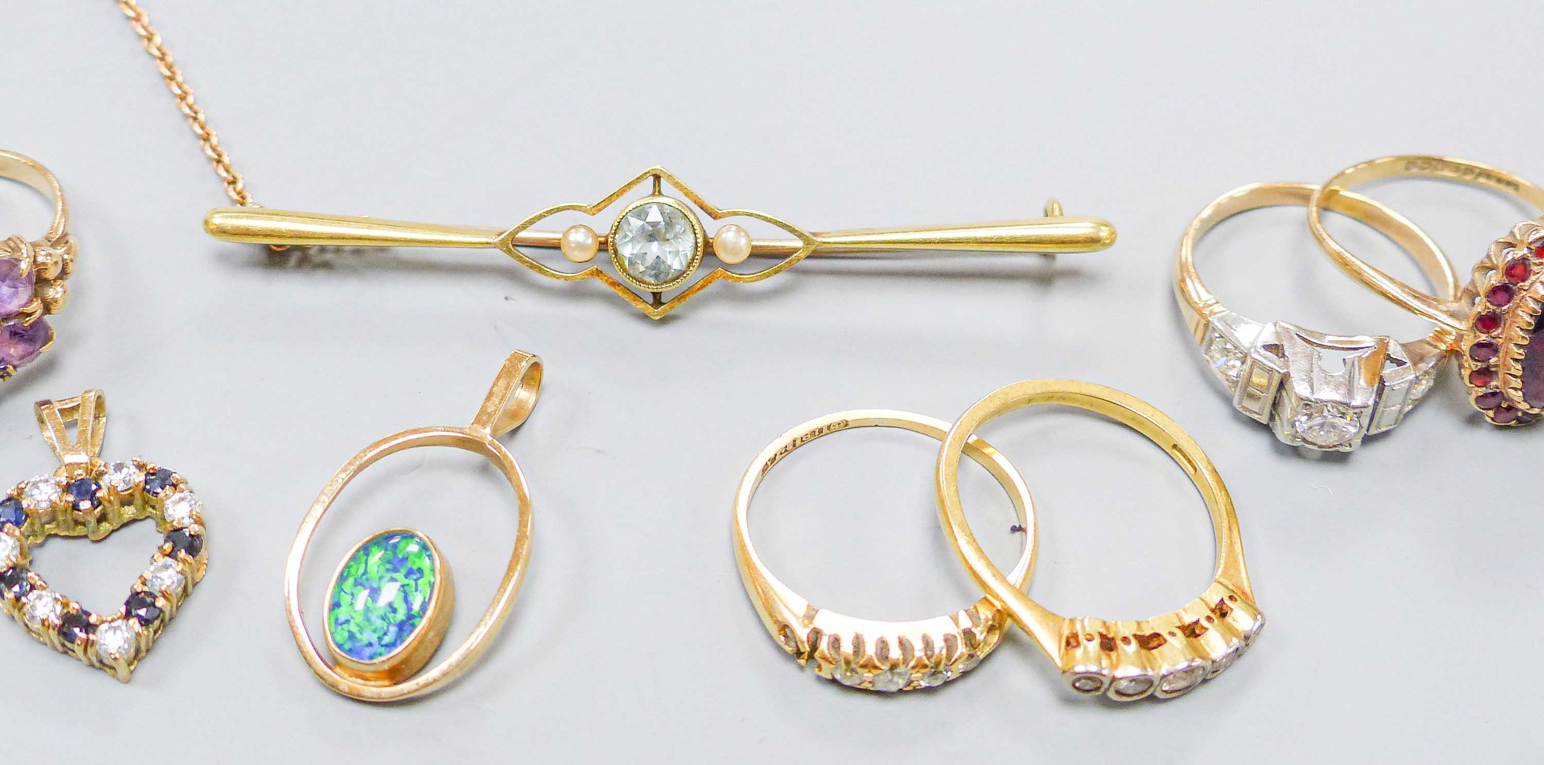 Three 18ct gold and gem set rings including two five stone half hoop(one stone missing) and a sapphire and diamond three stone, gross weight 7.3 grams, four 9ct and gem set rings and a 9ct pendant, gross 11.8 grams, a 15